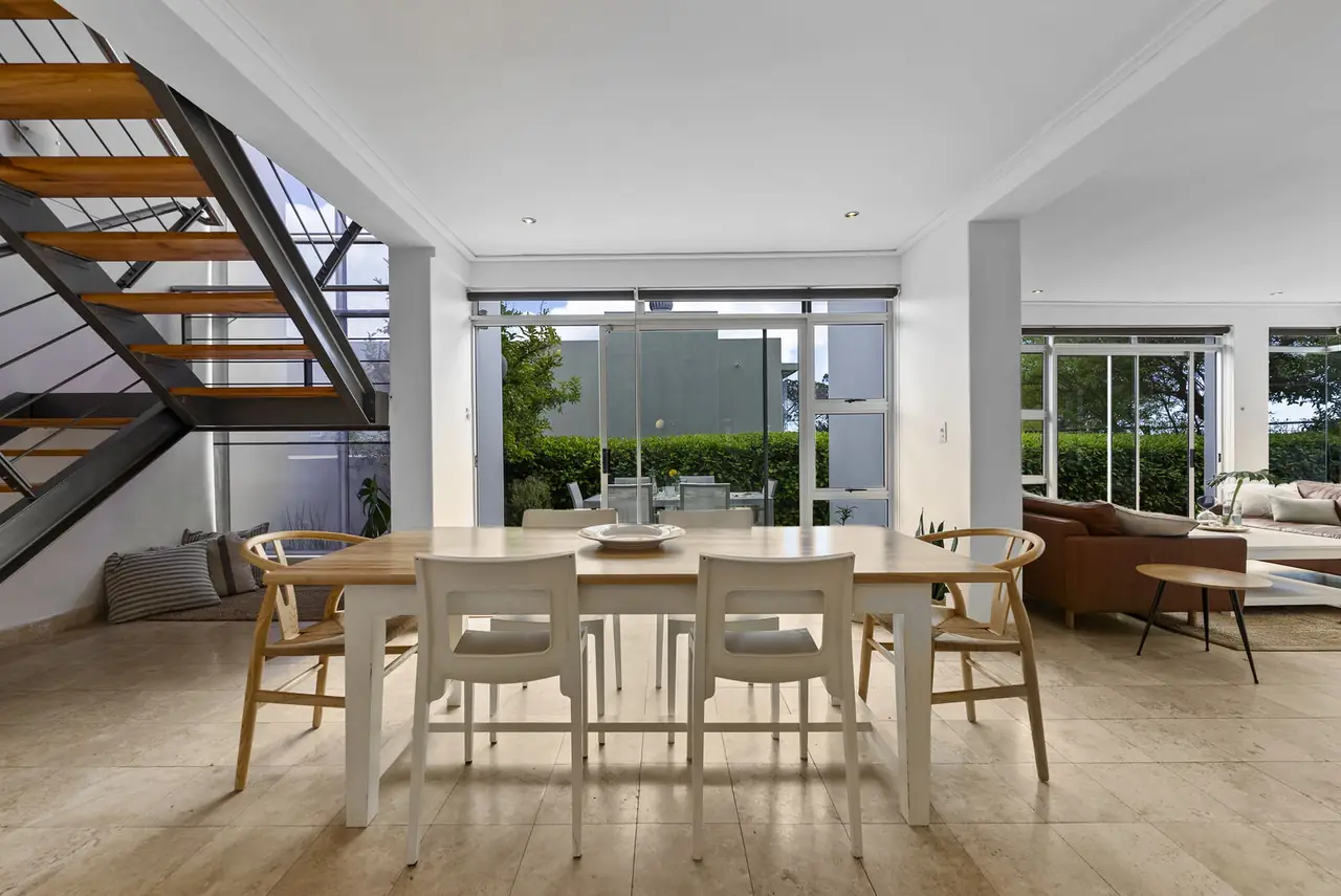 Dining table for six between the stairs and the lounge